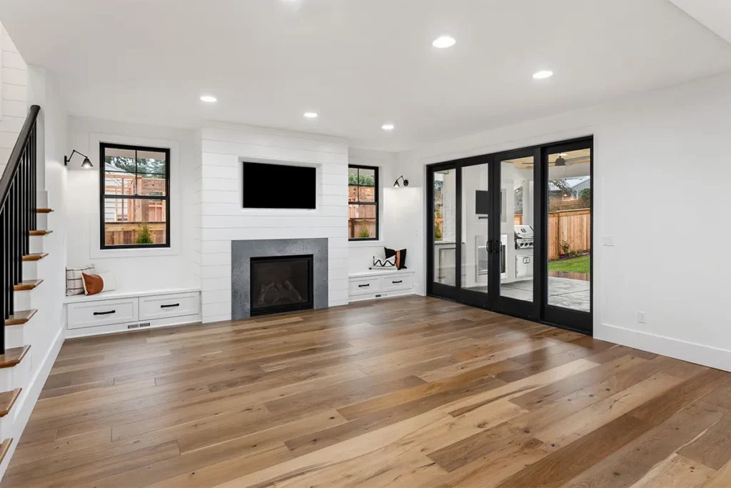 Home remodeling Studio City with living room fireplace and black glass doors, Athenian Builders