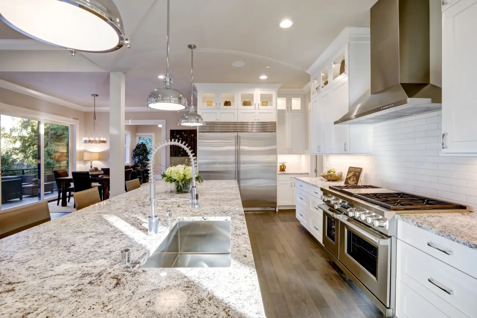 Kitchen island sink and stainless appliances in Studio City by Athenian Builders