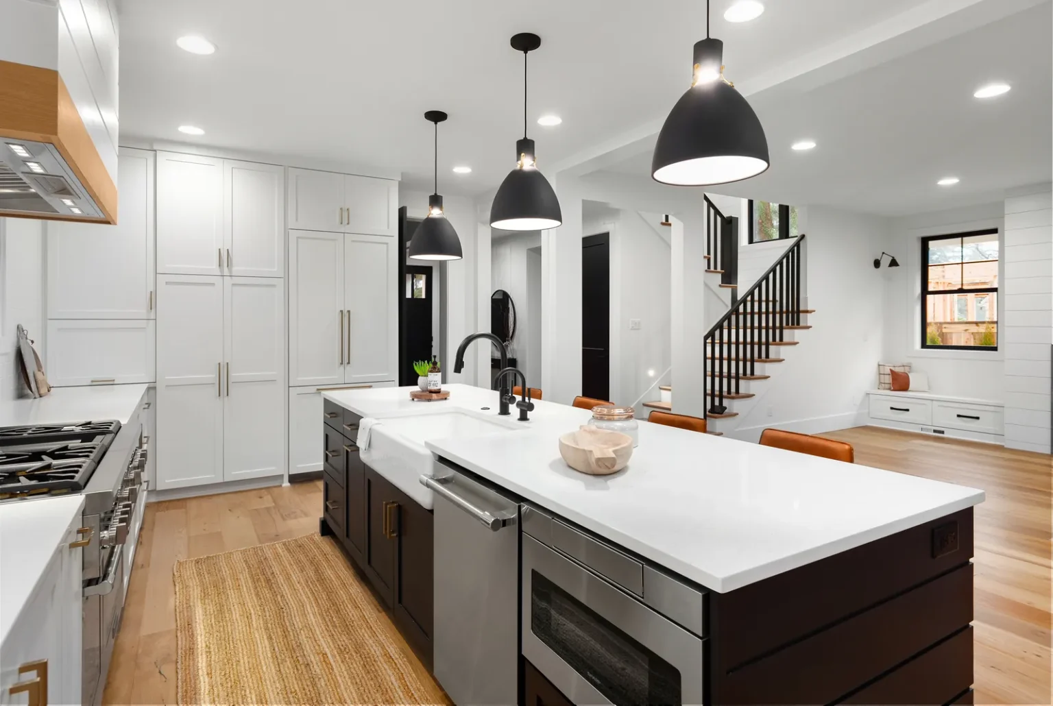 Open concept kitchen black island farmhouse sink in West Hollywood by Athenian Builders