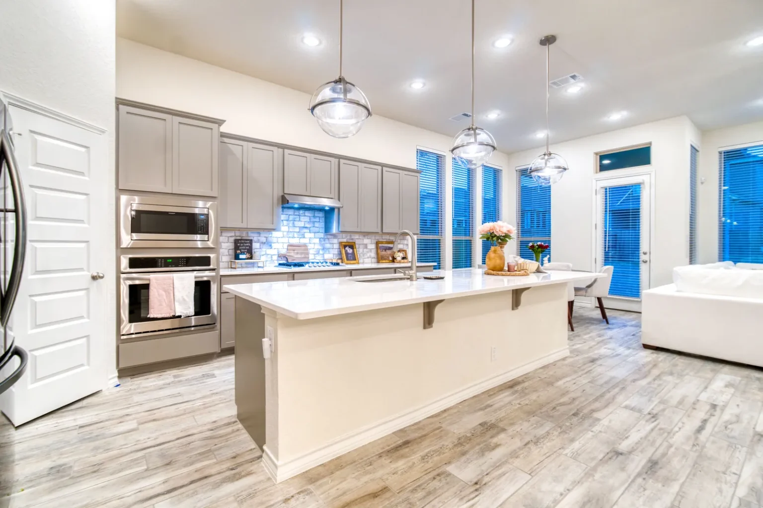 Open kitchen double wall ovens in North Hollywood by Athenian Builders