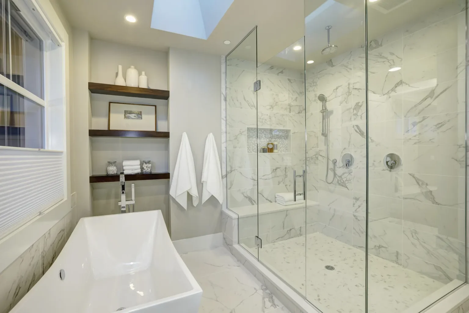 Primary bath tub and walk in shower in Santa Monica by Athenian Builders