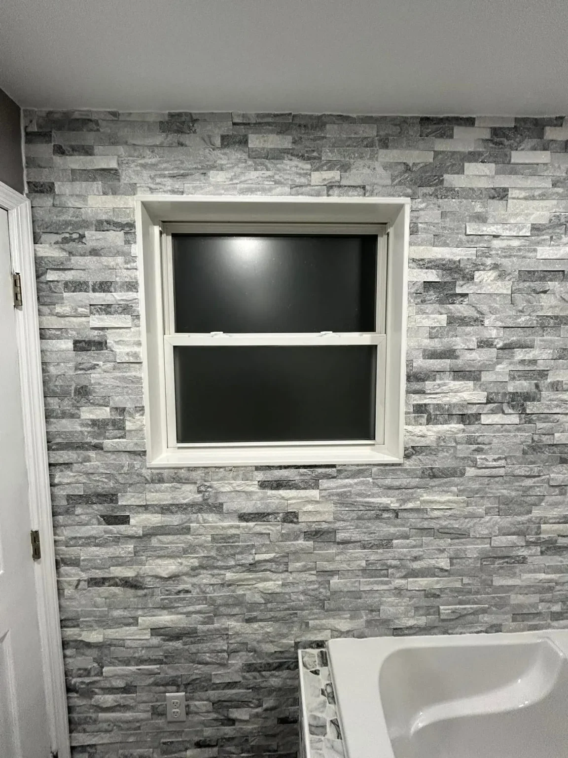Bathroom stone wall in Encino by Athenian Builders