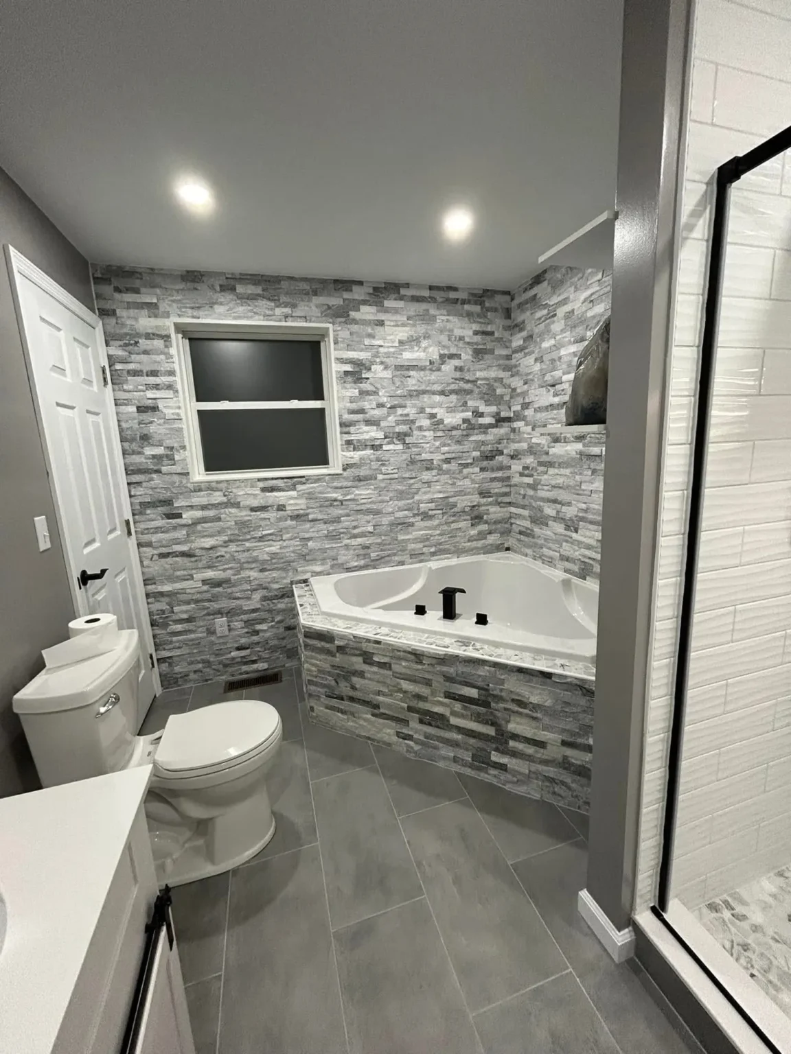 Bathroom tub window in Encino by Athenian Builders