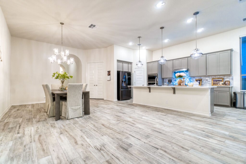 Flooring installation in San Fernando Valley: an open-concept living space with new light hardwood flooring, by Athenian Builders Group